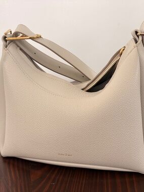 Chic cream shoulder bag by Polene. Smooth leather finish. Ideal for everyday use